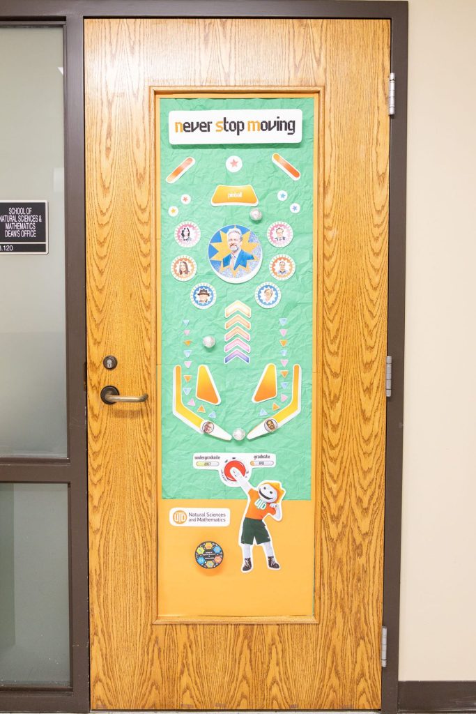 Homecoming Door Decoration: A pinball game decorated with NSM staff members 'Never Stop Moving' - FN 3.120