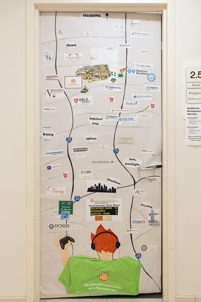 Homecoming Door Decoration - A student uses a game controller to navigate healthcare destinations in DFW area. - JSOM 2.501