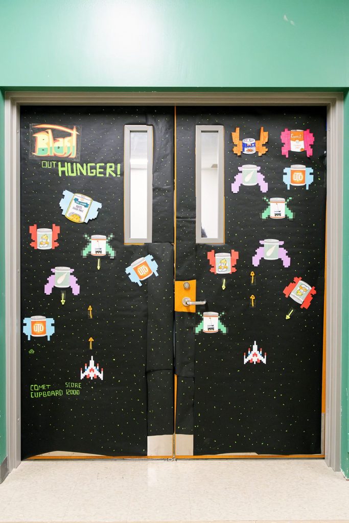 Homecoming Door Decoration: Scene from Galaga video game with message 'Blast Out Hunger' - MC 1.601